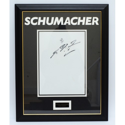 35 - Michael Schumacher, a signed and mounted white Ferrari fabric panel, 61 x 48cm overall. (1 item)