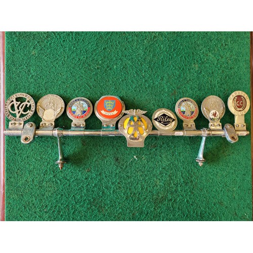 66 - Desmo badge bar with nine various badges (AA, St Christopher, Caravan Club, VCC, Riley Club, Hull, e... 