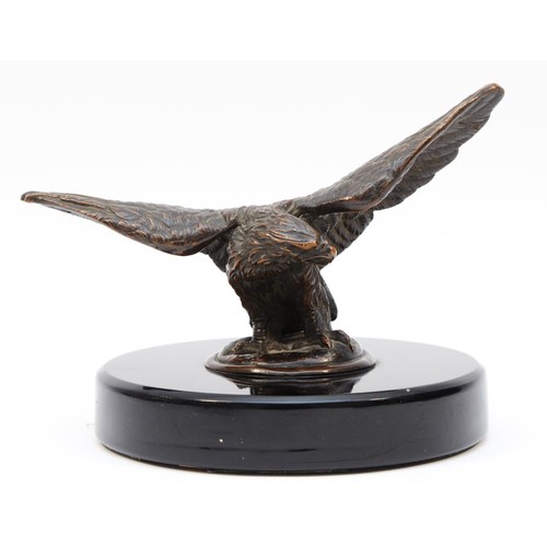 72 - A vintage bronzed model of an eagle, wing span 17.5cm, mounted on a black glass base. (1 item)