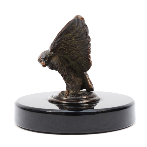 72 - A vintage bronzed model of an eagle, wing span 17.5cm, mounted on a black glass base. (1 item)