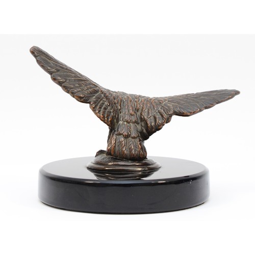 72 - A vintage bronzed model of an eagle, wing span 17.5cm, mounted on a black glass base. (1 item)