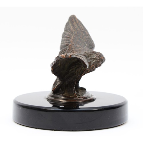 72 - A vintage bronzed model of an eagle, wing span 17.5cm, mounted on a black glass base. (1 item)