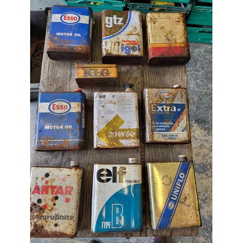 80 - A selection of nine 2-litre oil tins, including Esso, Elf, Shell, plus a French KLG spark plug tin. ... 