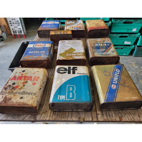 80 - A selection of nine 2-litre oil tins, including Esso, Elf, Shell, plus a French KLG spark plug tin. ... 