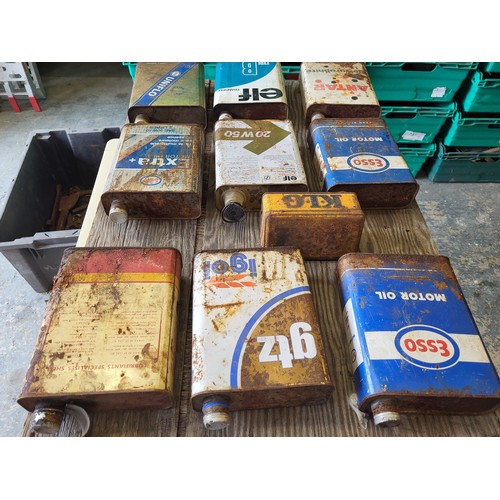 80 - A selection of nine 2-litre oil tins, including Esso, Elf, Shell, plus a French KLG spark plug tin. ... 