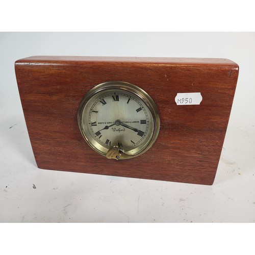 92 - A Watford Dashboard Clock, by North and Sons. Mounted in a Wooden Plaque. A Smiths, mounted in an ar... 