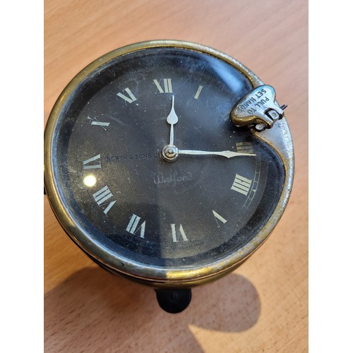 109 - Watford Car Clock, by North and Sons. Black face, front key wind, with securing ring and collar. (1 ... 