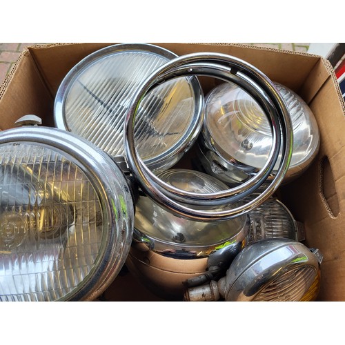 122 - A good quantity of classic car lights, including Lucas. (Four Boxes)