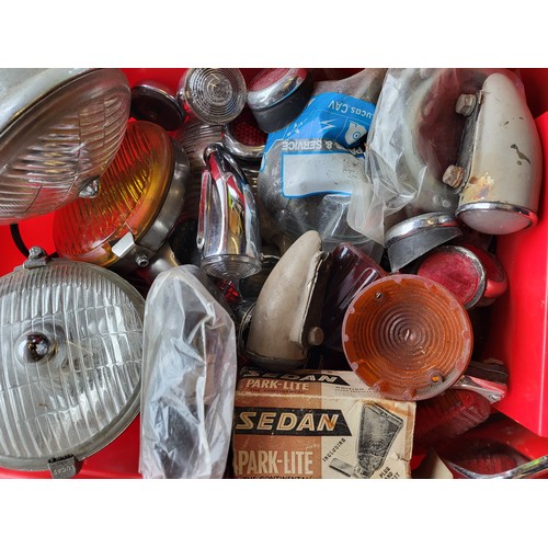 122 - A good quantity of classic car lights, including Lucas. (Four Boxes)