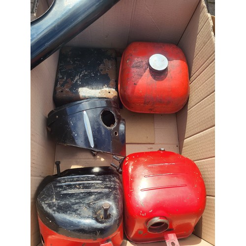 148 - Two boxes of motorcycle body parts, including two fuel tanks, oil tank, toolbox, forks, headlight su... 