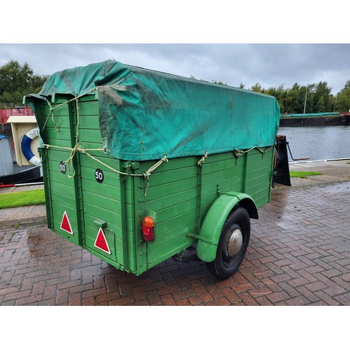 207 - A vintage car trailer, steel chassis, wooden plank construction, hinged drop down rear ramp, tarpaul... 