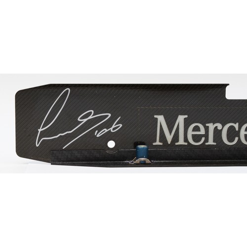 18 - Lewis Hamilton/Mikka Hakkinen, a signed Mercedes Benz carbon fibre engine plate, 44 x 7cm, together ... 