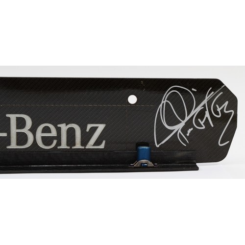 18 - Lewis Hamilton/Mikka Hakkinen, a signed Mercedes Benz carbon fibre engine plate, 44 x 7cm, together ... 