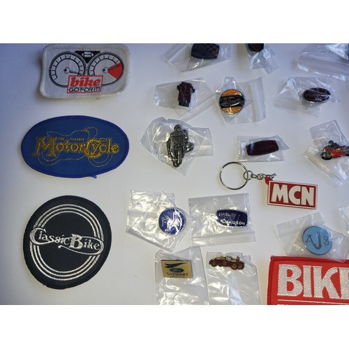 78 - A collection of approximately 40 motorcycle related pin badges and patches.