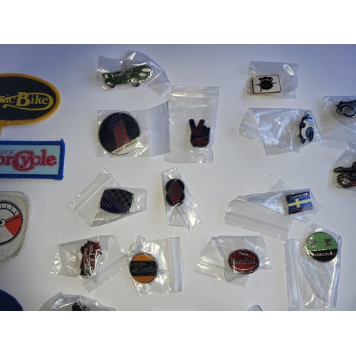 78 - A collection of approximately 40 motorcycle related pin badges and patches.