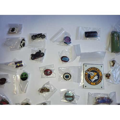 78 - A collection of approximately 40 motorcycle related pin badges and patches.