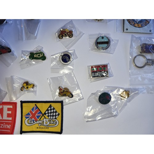 78 - A collection of approximately 40 motorcycle related pin badges and patches.