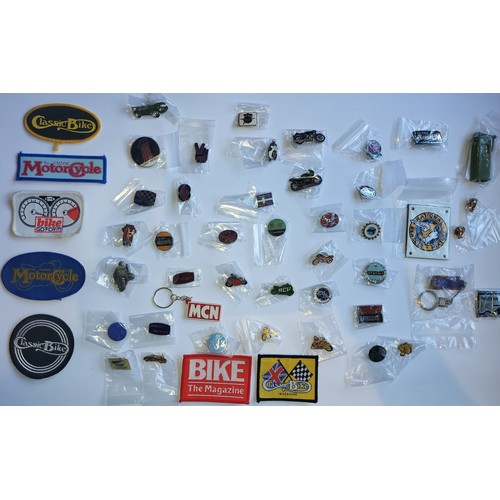 78 - A collection of approximately 40 motorcycle related pin badges and patches.