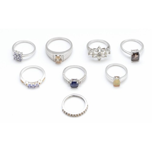 21 - Eight silver and gemset rings, to include opal and tanzanite, L - W, 27gm