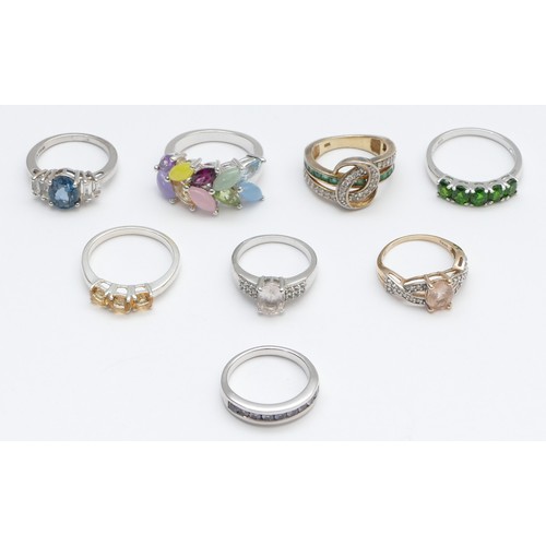 22 - Eight silver and gemset rings, to include emerald and tanzanite, L - R, 54gm