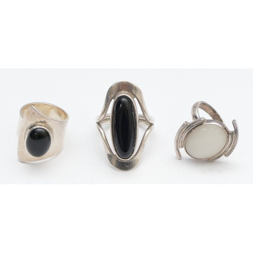 26 - A Mexican silver and onyx ring, by Dominique Dinonart, size U and two other Mexican silver rings, 37... 