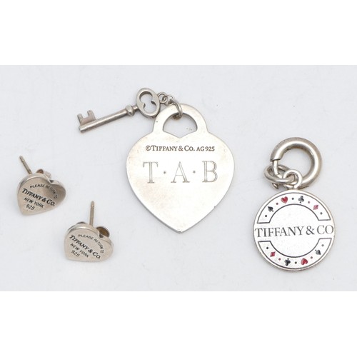 49 - Tiffany & Co. a silver and enamel Las Vegas gambling token, a heart pendant and a pai of ear studs, ... 