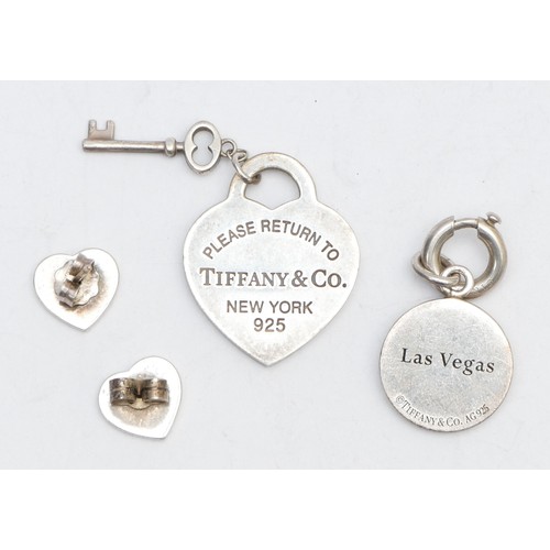 49 - Tiffany & Co. a silver and enamel Las Vegas gambling token, a heart pendant and a pai of ear studs, ... 