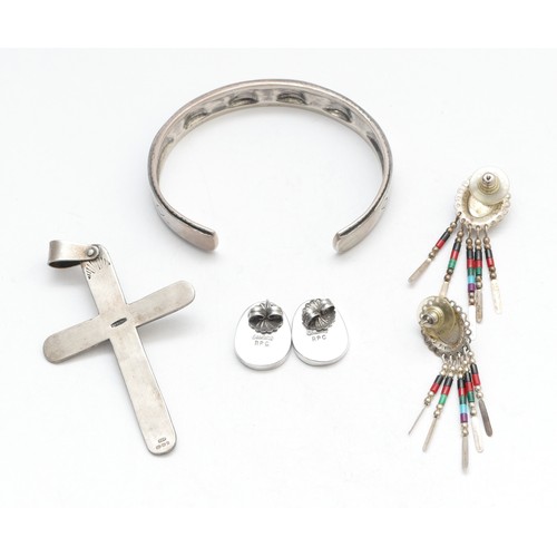 54 - A Native American silver and stone set bangle, a cross pendant and two pairs of ear rings, 49gm