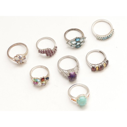 56 - Eight silver and gemset rings, including tanzanite and opal, O - T, 30gm