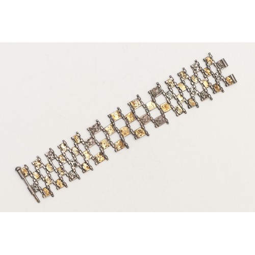 57 - A Modernist 925 silver/750 gold open panel link bracelet, 18cm, 48gm