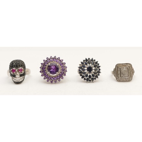 73 - A silver and gemstone set skull ring, M and three other silver gemset rings, 27gm