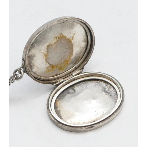 74 - A Victorian unmarked silver oval locket, 36 x 30mm, chain, 20gm