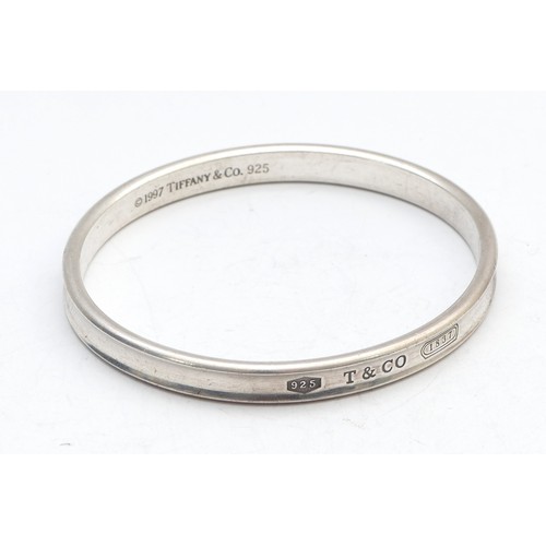 75 - Tiffany & Co., a silver concave bangle, dated 1997, 65 x 58mm, 35gm