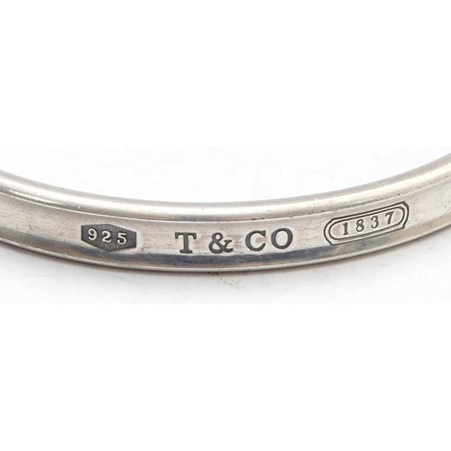 75 - Tiffany & Co., a silver concave bangle, dated 1997, 65 x 58mm, 35gm