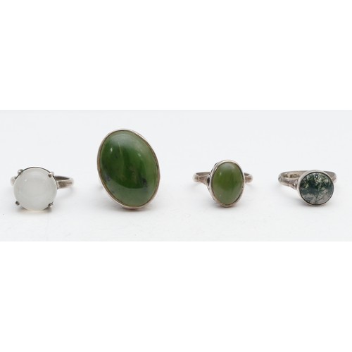 86 - A silver and nephrite jade ring, N and three other rings, 21gm