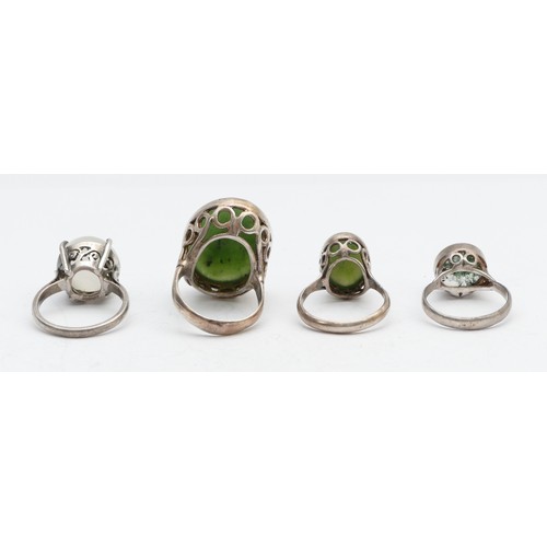 86 - A silver and nephrite jade ring, N and three other rings, 21gm