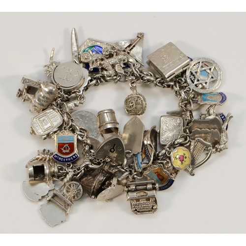 91 - A silver charm bracelet with multiple charms, 19cm, 88gm