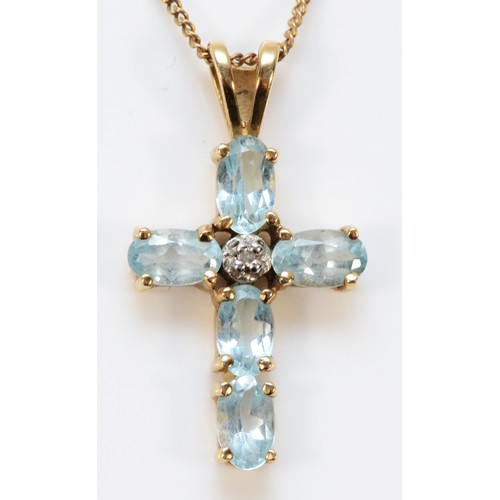 570 - A 9ct gold blue topaz and diamond cross pendant with chain, 16mm cross length, 2.2g