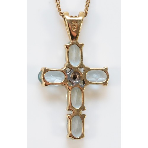 570 - A 9ct gold blue topaz and diamond cross pendant with chain, 16mm cross length, 2.2g