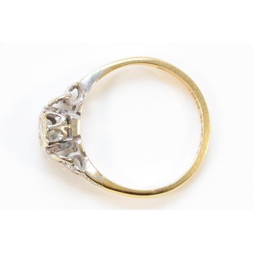 571 - An 18ct gold and platinum brilliant cut diamond solitaire ring with patterned shoulders, Birmingham ... 