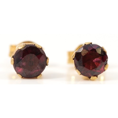 573 - A pair of 9ct gold garnet earrings with scroll backs, 5mm garnet, 1.1g