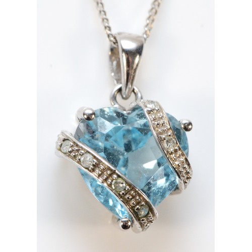 582 - A 9ct white gold diamond and topaz heart shaped pendant with chain, 10mm across, 2.3g