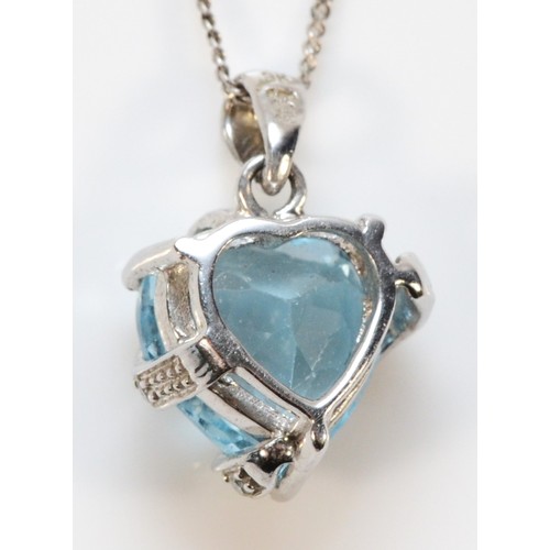 582 - A 9ct white gold diamond and topaz heart shaped pendant with chain, 10mm across, 2.3g