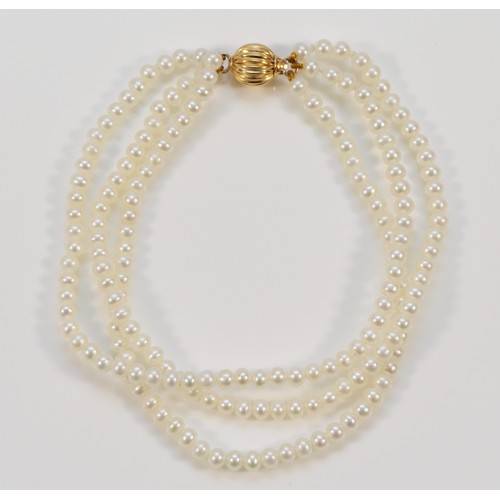 588 - A 9ct gold clasp cultured pearl three row bracelet, 19cm, 11.5g