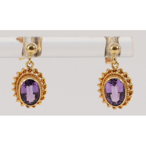 598 - A pair of 9ct gold oval cut amethyst drop earrings with scroll backs, 6mm x 4mm amethyst, 1.6g