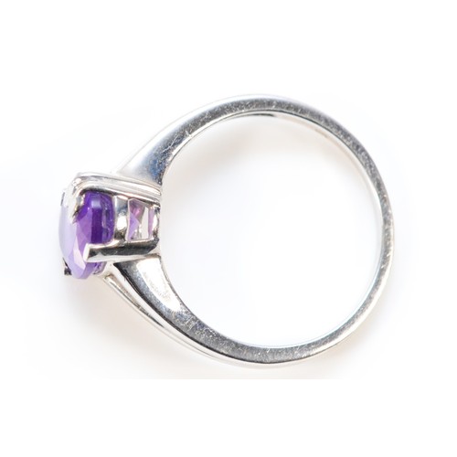 601 - A 9ct white gold oval cut amethyst dress ring with leaf detail, 9mm x 6mm amethyst, O, 3.4g