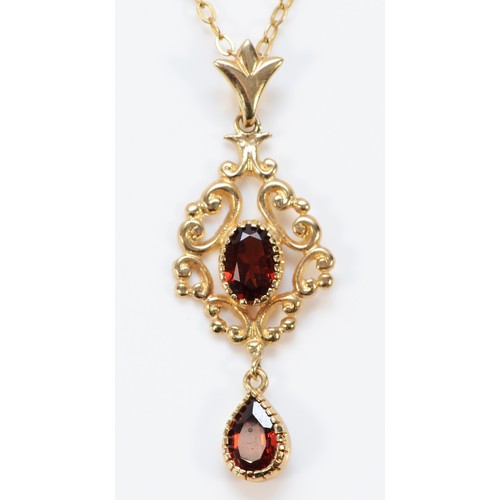 612 - A 9ct gold vintage style garnet pendant with a 9ct gold chain, 38mm total length, 3.1g