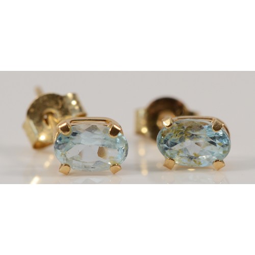 618 - A pair of 9ct gold blue topaz earrings with scroll backs, 0.5g