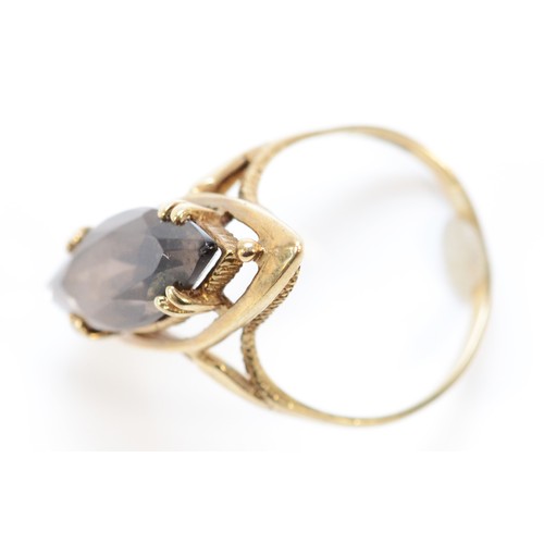 650 - A 9ct gold marquise cut smokey quartz cocktail ring, 20mm x 7mm quartz, N, 3.7g