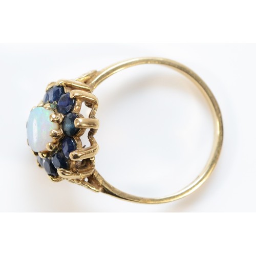 663 - A 9ct gold opal and sapphire cluster ring, M, 2.9g